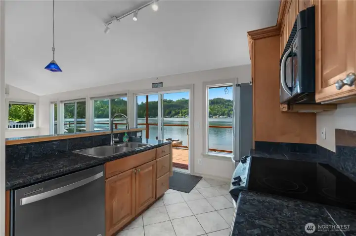 Kitchen area offers lake views, maple cabinetry, granite tile counters, and stainless appliances. Kitchen area offers lake views, maple cabinetry, granite tile counters, and stainless appliances.