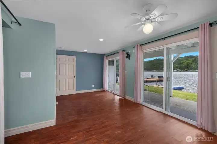 Spacious PBr offers lake views, patio access, and warm plank-style flooring. Spacious PBr offers lake views, patio access, and warm plank-style flooring.