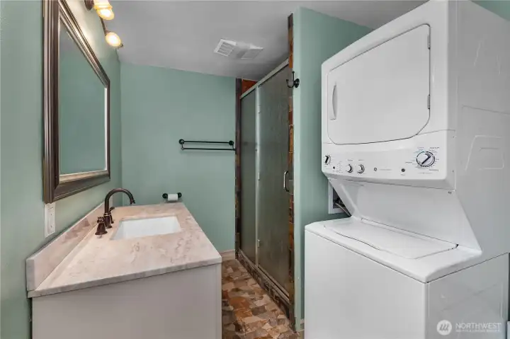 PBR - Bathroom and laundry area includes vanity, shower, and stacked washer/dryer for added convenience. PBR - Bathroom and laundry area includes vanity, shower, and stacked washer/dryer for added convenience.