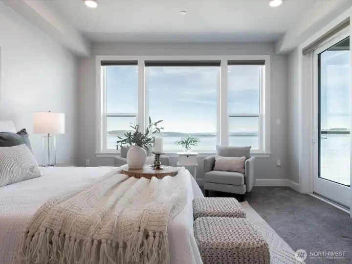 Wake up to panoramic water views and enjoy direct access to the wraparound deck from this, your spacious primary suite. Wake up to panoramic water views and enjoy direct access to the wraparound deck from this, your spacious primary suite.