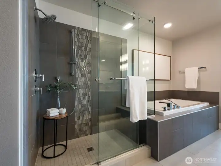 The spa-inspired primary bath features a frameless glass shower, soaking tub, designer tilework, and timeless finishes throughout. The spa-inspired primary bath features a frameless glass shower, soaking tub, designer tilework, and timeless finishes throughout.