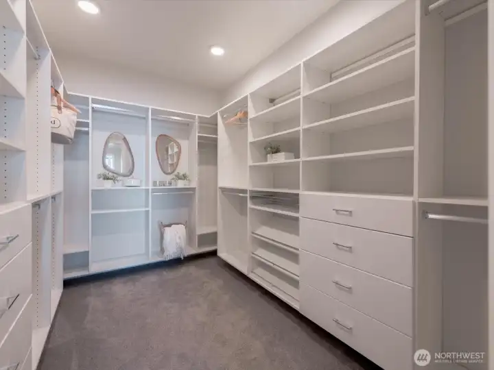 An impressive custom walk-in closet features extensive shelving, drawers, and wardrobe storage designed to keep everything beautifully organized. An impressive custom walk-in closet features extensive shelving, drawers, and wardrobe storage designed to keep everything beautifully organized.