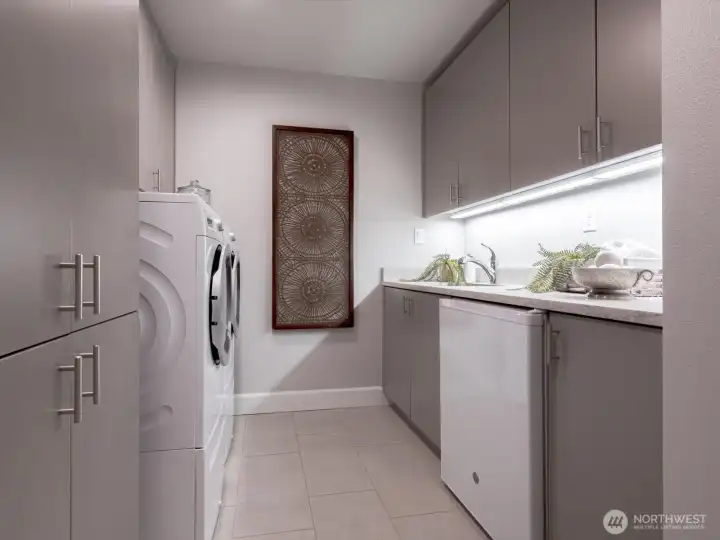 Dedicated laundry room with storage galore and small refrigerator. Sink with a pull-out faucet and under-cabinet lighting. There is another storage closet BEHIND the entry door on the right. Dedicated laundry room with storage galore and small refrigerator. Sink with a pull-out faucet and under-cabinet lighting. There is another storage closet BEHIND the entry door on the right.