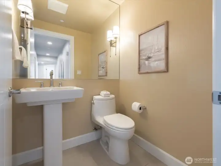 Guest powder room thoughtfully positioned off the main living areas. Guest powder room thoughtfully positioned off the main living areas.
