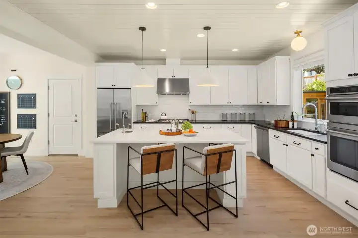 Updated kitchen with two-tone quartz countertops and GE Café oven, microwave, stove and dishwasher. Updated kitchen with two-tone quartz countertops and GE Café oven, microwave, stove and dishwasher.