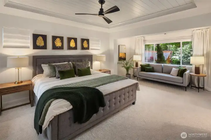 Grand primary Suite with shiplap ceiling and ceiling fan and windows on three sides. Grand primary Suite with shiplap ceiling and ceiling fan and windows on three sides.