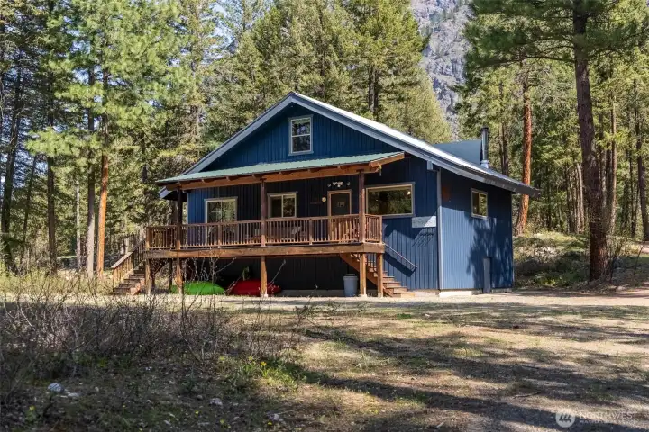 Exterior Front View: Tucked into 5 forested acres along the Methow River, this vintage cabin-style home blends seamlessly into its natural surroundings. A peaceful escape with mountain views and total privacy. Exterior Front View: Tucked into 5 forested acres along the Methow River, this vintage cabin-style home blends seamlessly into its natural surroundings. A peaceful escape with mountain views and total privacy.