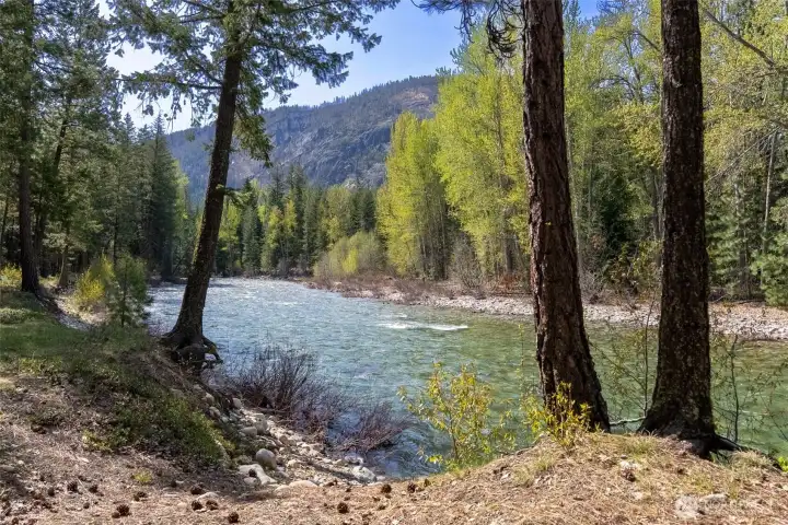 Easy river access. River frontage framed by towering pines and mountain views. Easy river access. River frontage framed by towering pines and mountain views.