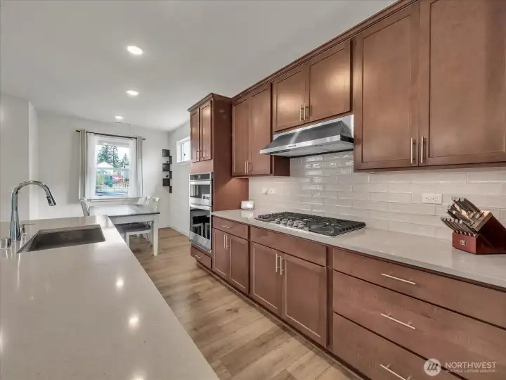 High-end gas range + stainless steel appliances.