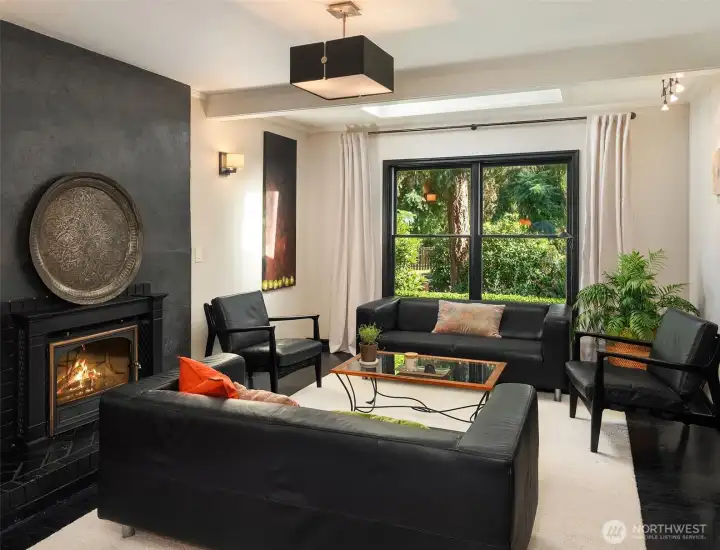The living room invites you to gather by the fire while enjoying seamless flow to the dining room and outdoor living spaces.