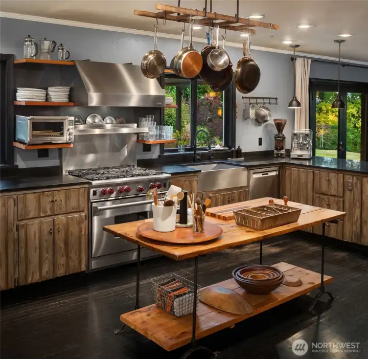 Professional-grade appliances, abundant workspace, and garden views make this kitchen a true destination within the home.
