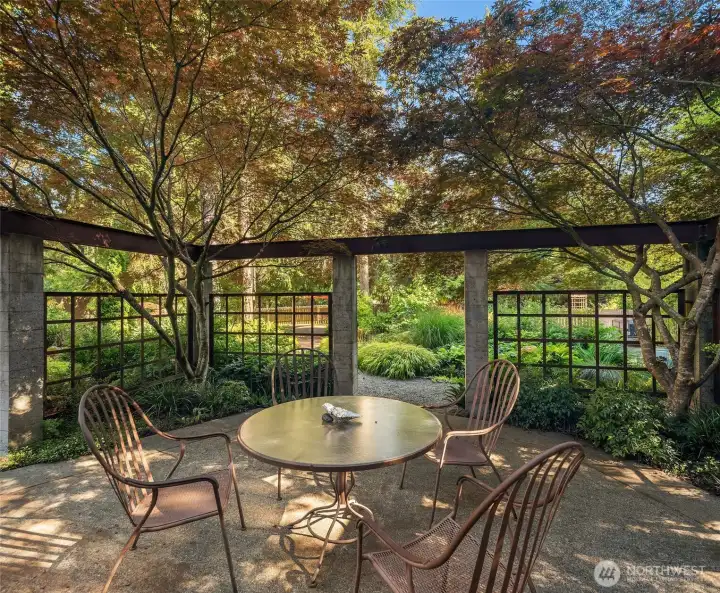 Tucked among mature Japanese maples and lush landscaping, this secluded garden patio offers a peaceful place to unwind.