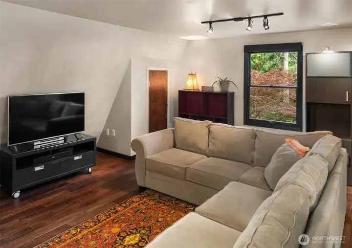 Comfortable and inviting, this upstairs gathering room is perfect for movies, reading, or everyday relaxation.