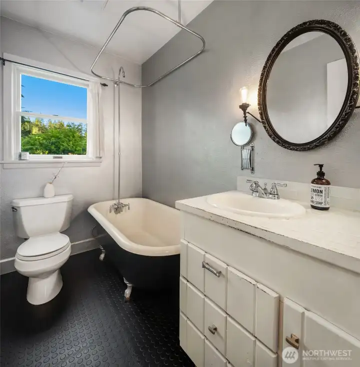Vintage-inspired details lend character to the upstairs bathroom, complete with a classic clawfoot soaking tub.