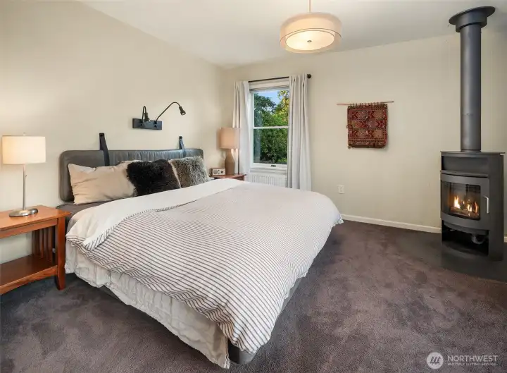 Tucked away from the home's gathering spaces, the primary suite provides privacy, comfort, and a connection to the surrounding landscape.