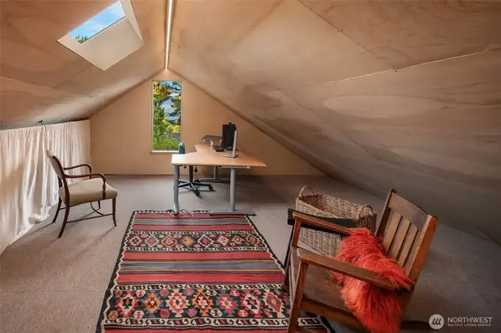 Tucked away at the top of its own private staircase, this finished attic retreat offers a quiet and inspiring space for work, creativity, or relaxation.