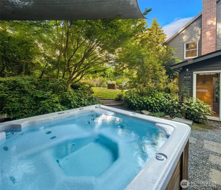 Unwind beneath the trees in the secluded hot tub, thoughtfully positioned near the sauna and outdoor shower.