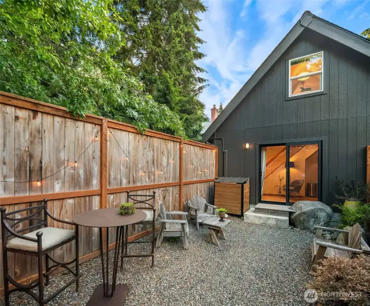 Tucked away from the main residence, this detached studio offers privacy, flexibility, and its own inviting outdoor retreat.