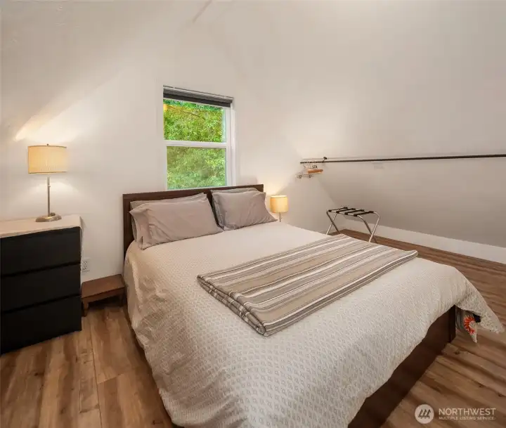 The loft retreat provides a cozy sleeping area tucked above the main living space.