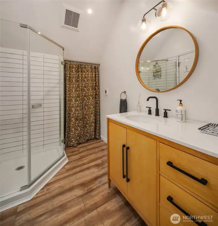 Well-appointed bathroom with radiant in-floor heat completes this versatile detached retreat.