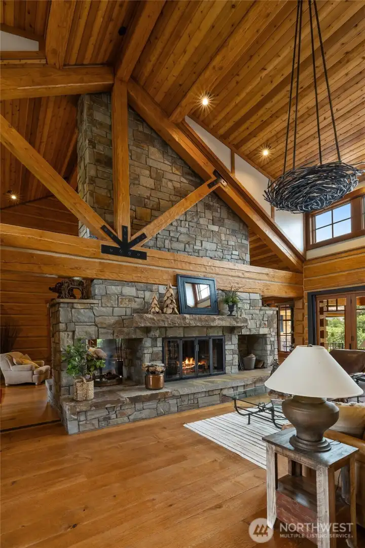 Fireplace built from hand picked Montana stone featuring custom metal lighting