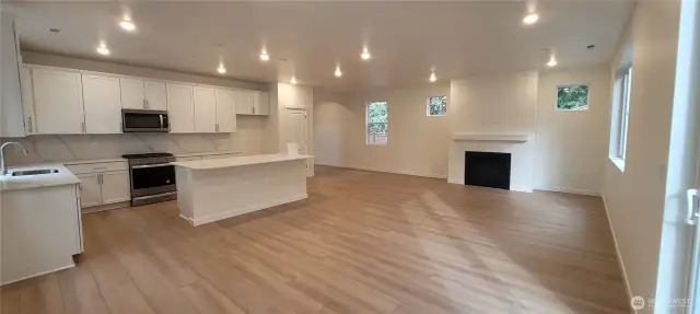 Great room with kitchen gas stove and fireplace