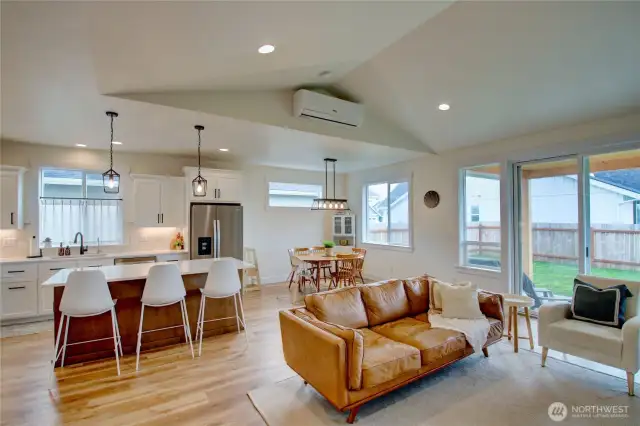 Large windows bring in natural light, slider door out to covered back patio.