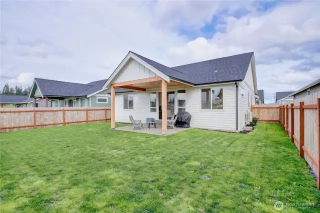 Large, fully fenced back yard with covered patio.