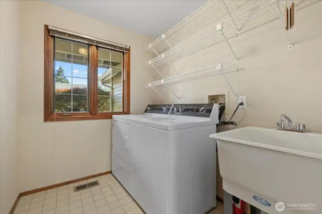 Laundry room with convenient utility sink.