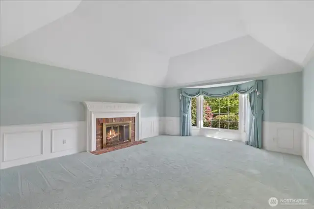 Views of the lovely living room featuring a beautiful traditional brick surround fireplace.