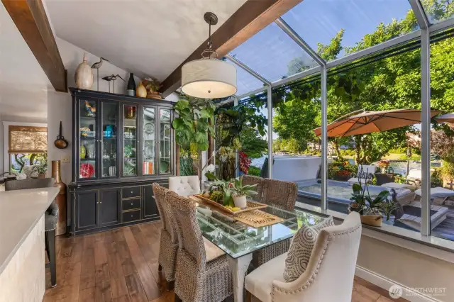 Informal dining space w/waterfront views & French doors that open to wrap around porch leading to the spa, gazebo, gardens & waterfront spaces.