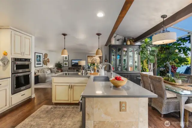 Chefs kitchen w/travertine island, quartz countertops, stainless steel appliances, deep stainless steel sink & soft close cabinets.