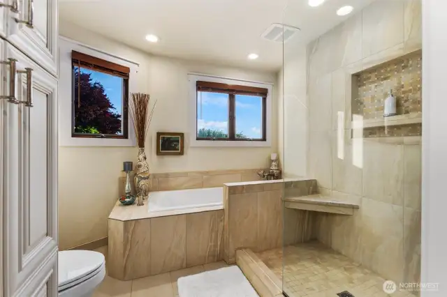 Tile wrapped soaking tub & custom shower w/seamless design.