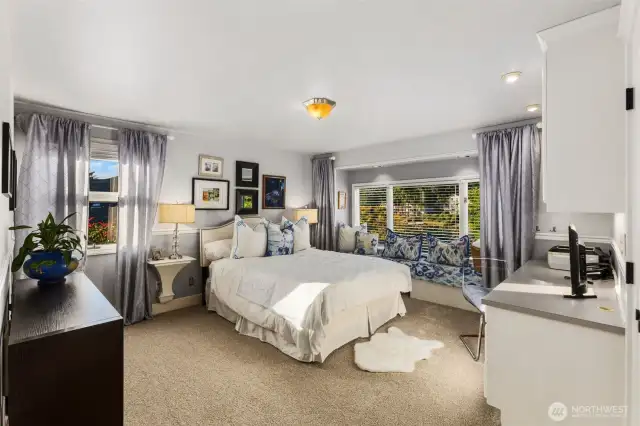 Large second bedroom suite w/custom built in desk & window seating overlooking lake & gardens.