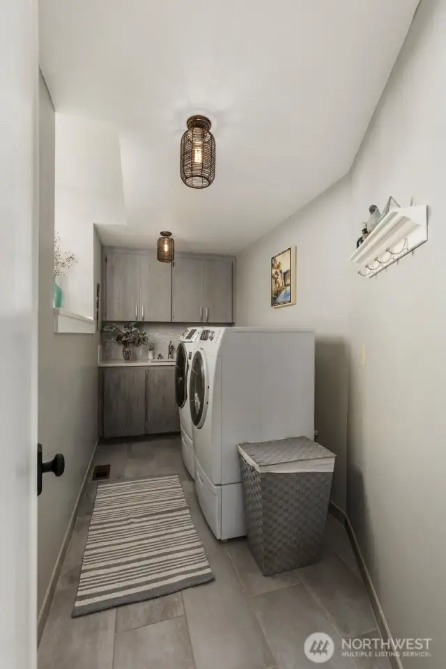 Large upper floor laundry room w/sink & extra storage.