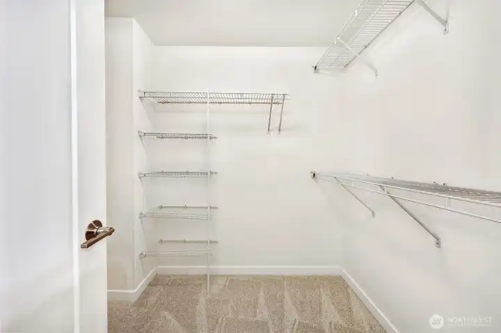 Primary bedroom walk-in closet