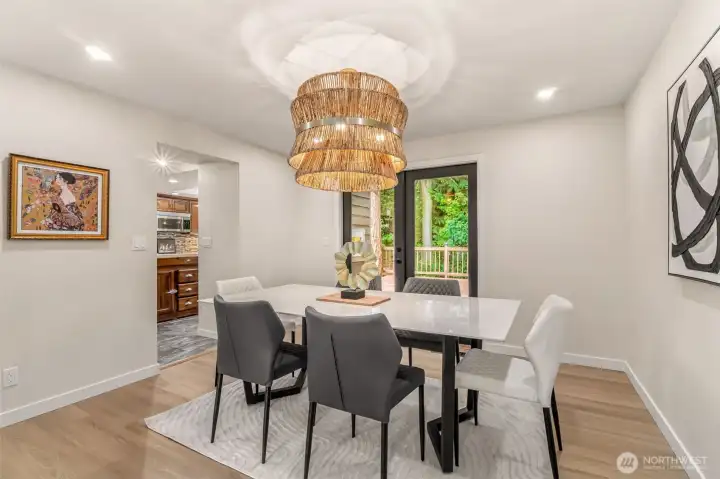 Formal dining leads right to an expansive deck, that was built around a tree!