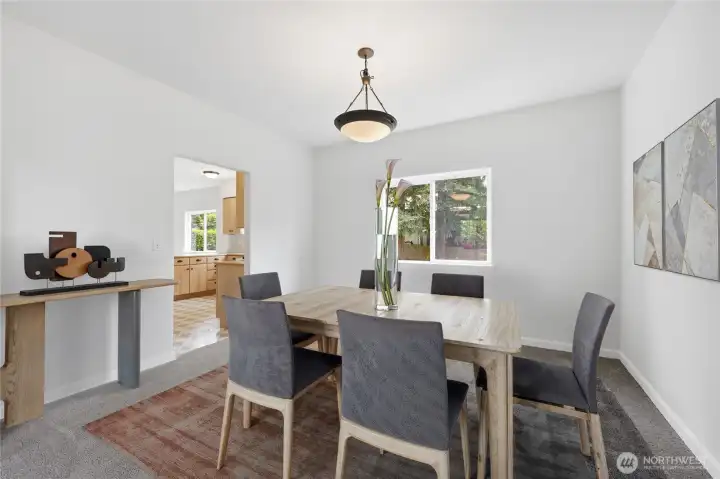The roomy dining room is virtually staged.