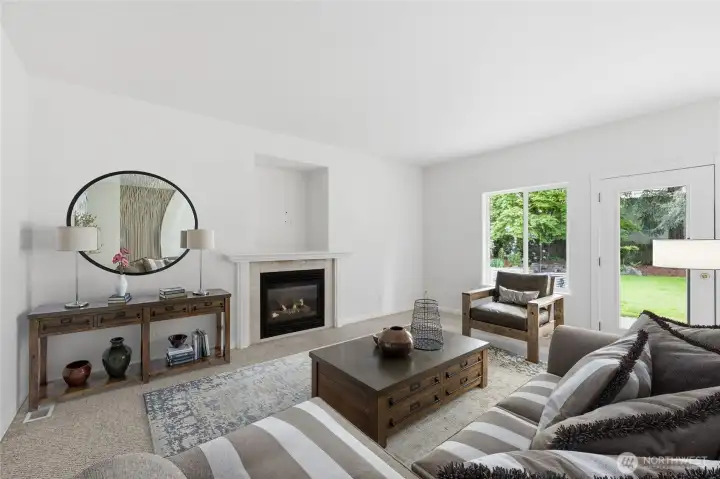 The family room flowing off from the kitchen is a nice place to gather is virtually staged.