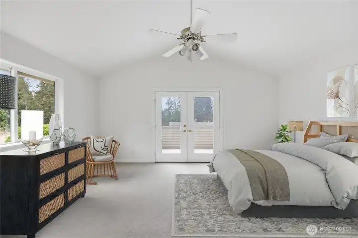 The primary bedroom ensuite with French doors leading onto the deck is virtually staged.