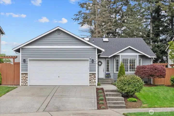 Beautifully maintained Wilderun rambler featuring fresh exterior paint, manicured landscaping, & timeless curb appeal.