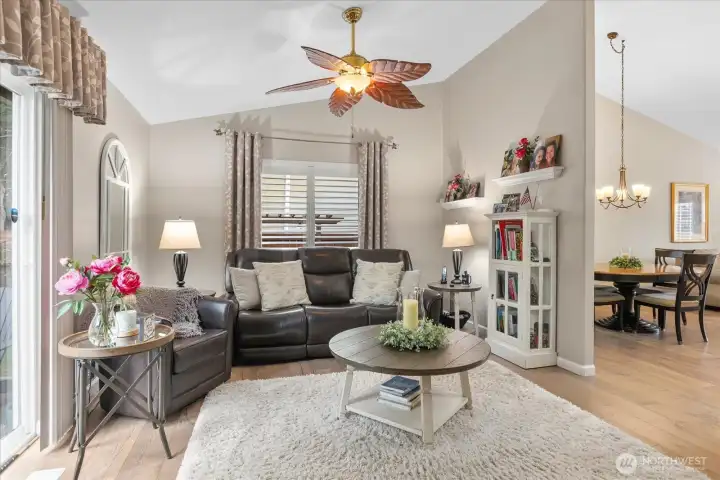 Cozy gathering space featuring plantation shutters, updated flooring, & abundant natural light throughout.