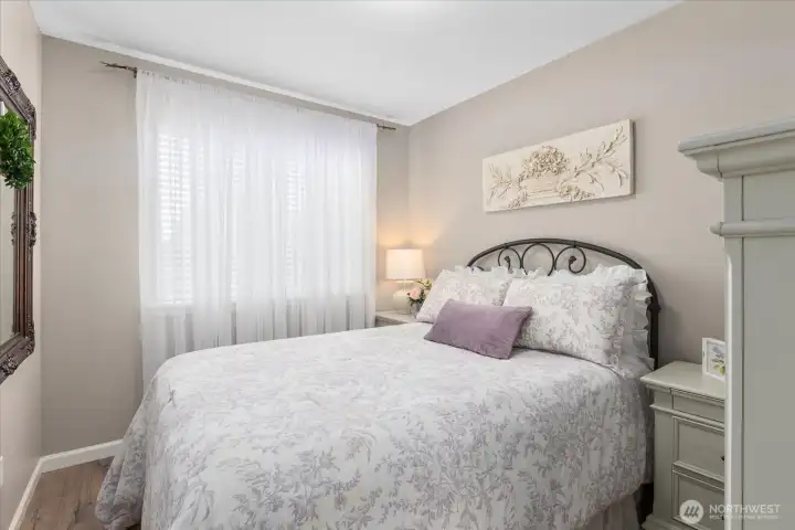 Comfortable secondary bedroom filled w/ soft natural light & neutral finishes.