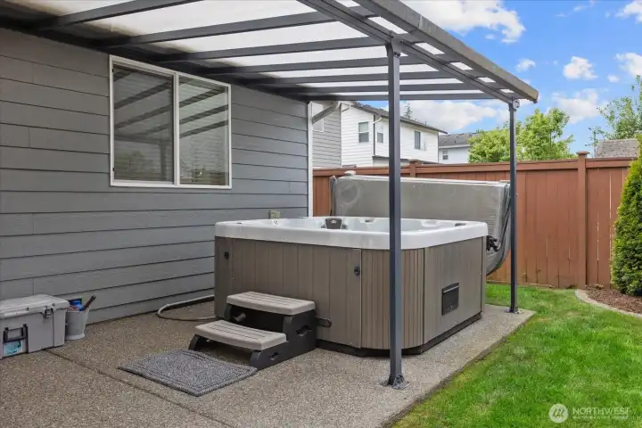 Relax & unwind year-round in the private hot tub tucked beneath the covered patio.