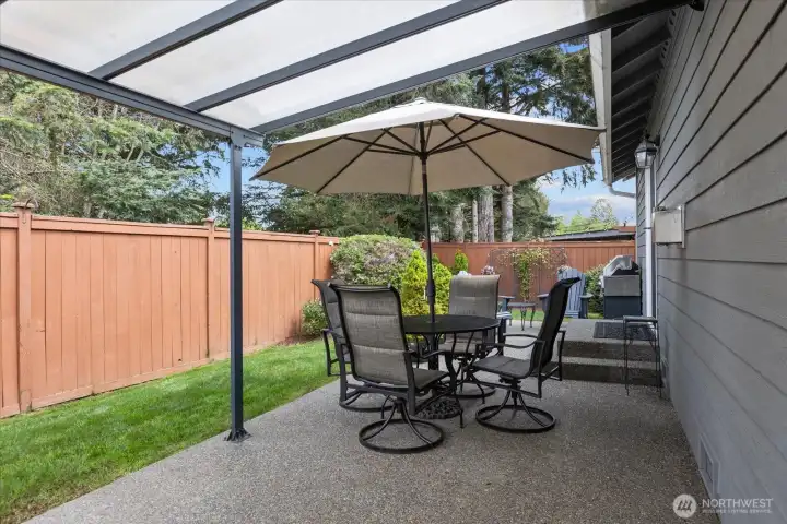 Low-maintenance backyard offers a great blend of patio space, green lawn, & mature landscaping.