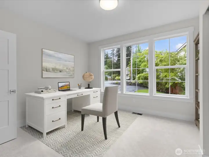 This versatile main-floor bedroom is an ideal space for a home office or guest suite. Virtual staging.