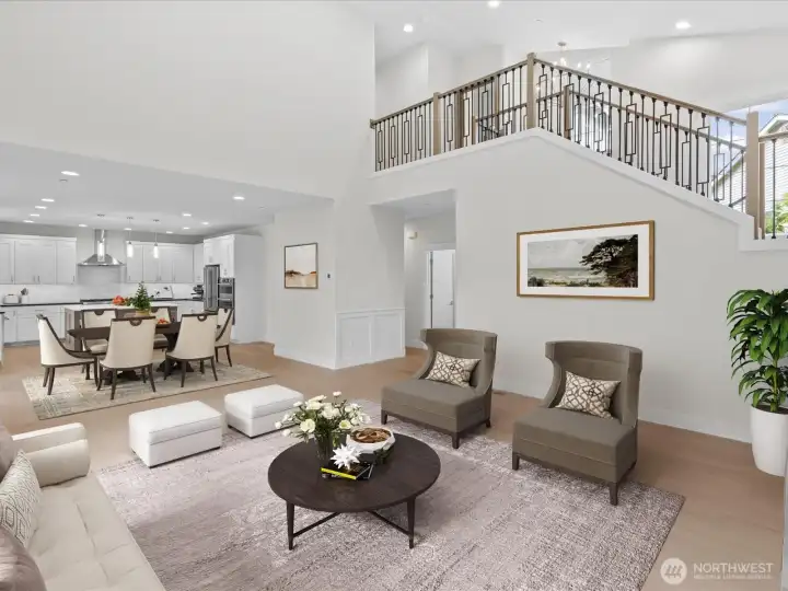 Seamless main-floor flow looking through the bright Great Room, casual dining area, and into the kitchen. An impressive open layout perfect for modern living and entertaining. Virtual staging.