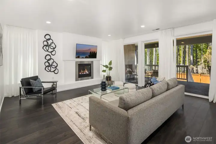 nviting great room with a contemporary fireplace, generous gathering space, and an open sightline to the kitchen, dining area, and covered outdoor room.
