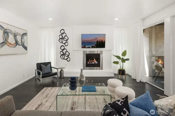 Spacious great room anchors the main level with a modern fireplace, clean architectural lines, and an effortless connection to indoor-outdoor living.