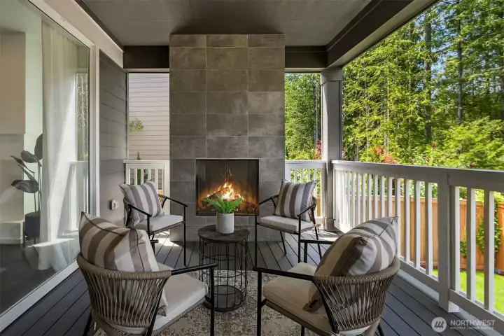 MainVue’s Signature Outdoor Room creates a covered year-round retreat with a tiled fireplace and generous seating space, overlooking a private greenbelt of mature native trees in an established, completed neighborhood.